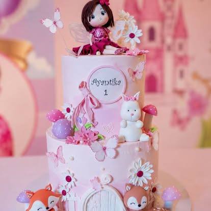Pink two-tier princess cake with a sugar doll, bunny, fox and butterflies